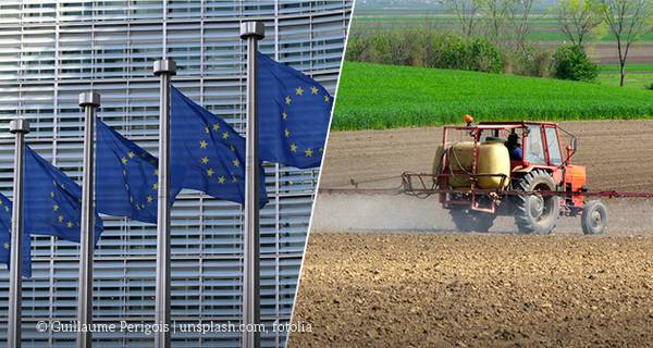 Flaggen der EU wehen, spritzender Traktor